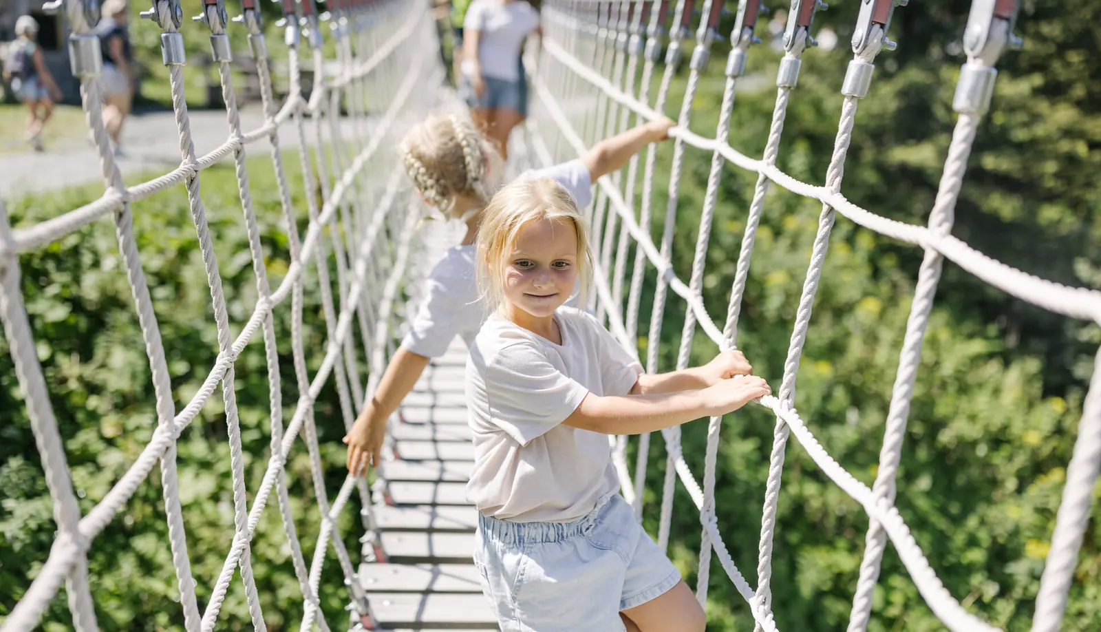 Kind auf einer Seilbrücke beim Sommererlebnis Streif am Hahnenkamm