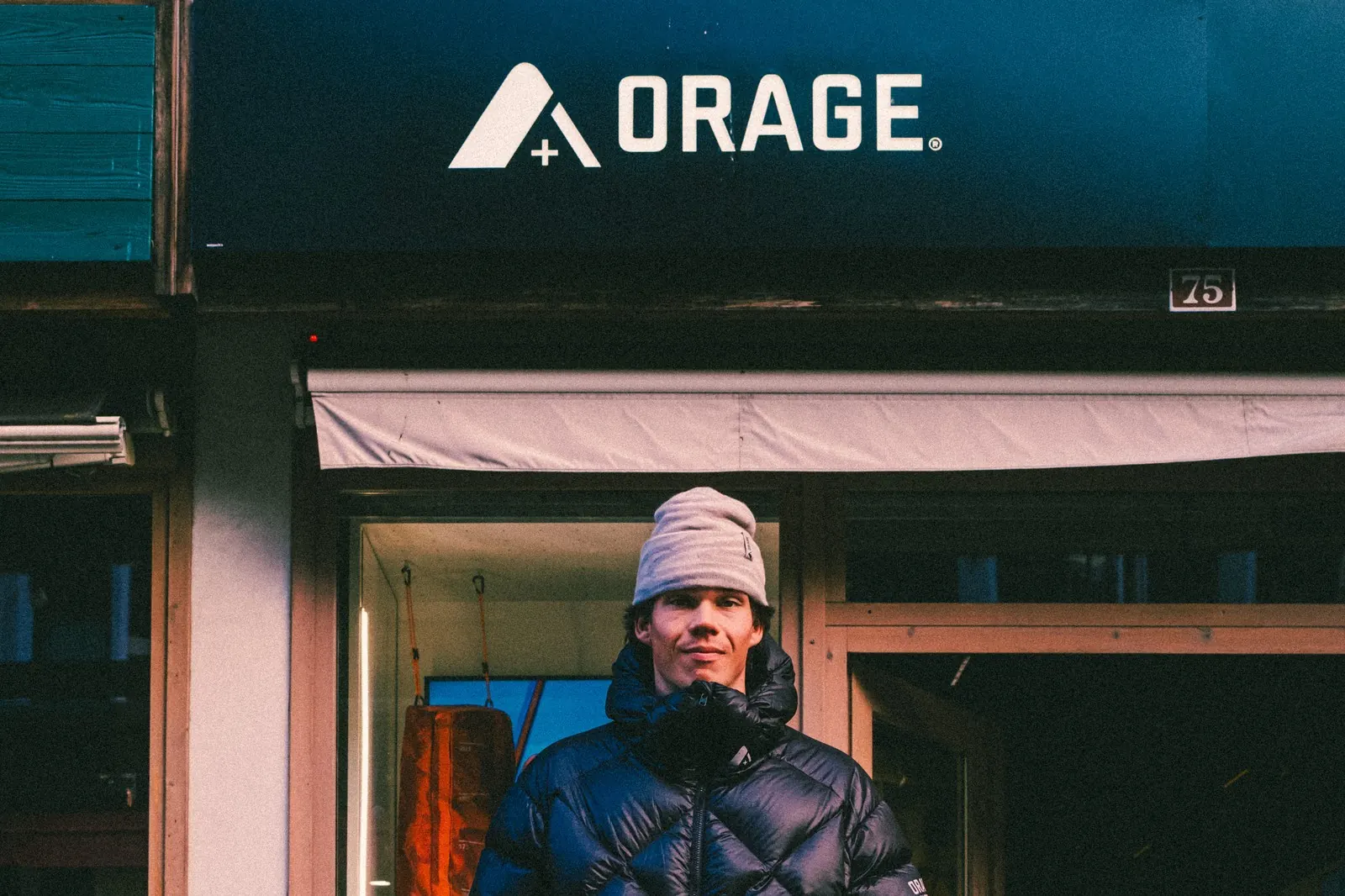 Man in a dark blue Orage down jacket outside the Orage shop in Chamonix