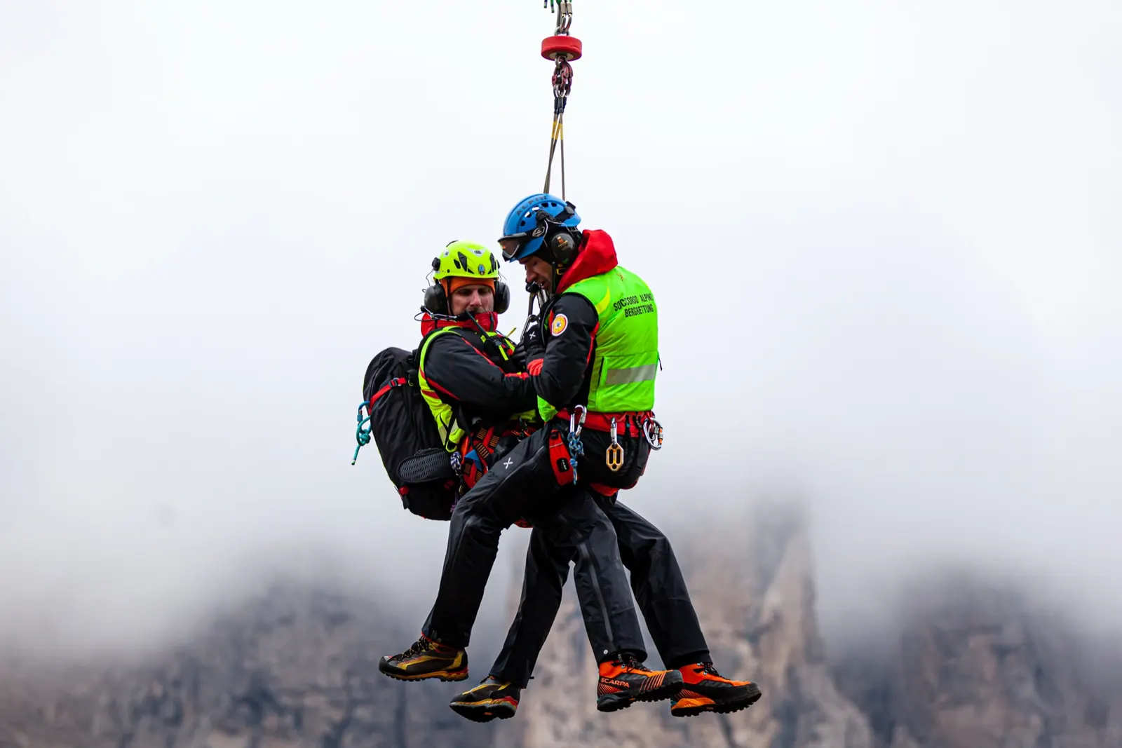Alto Adige mountain rescue helicopter operation in front of the Dolomites