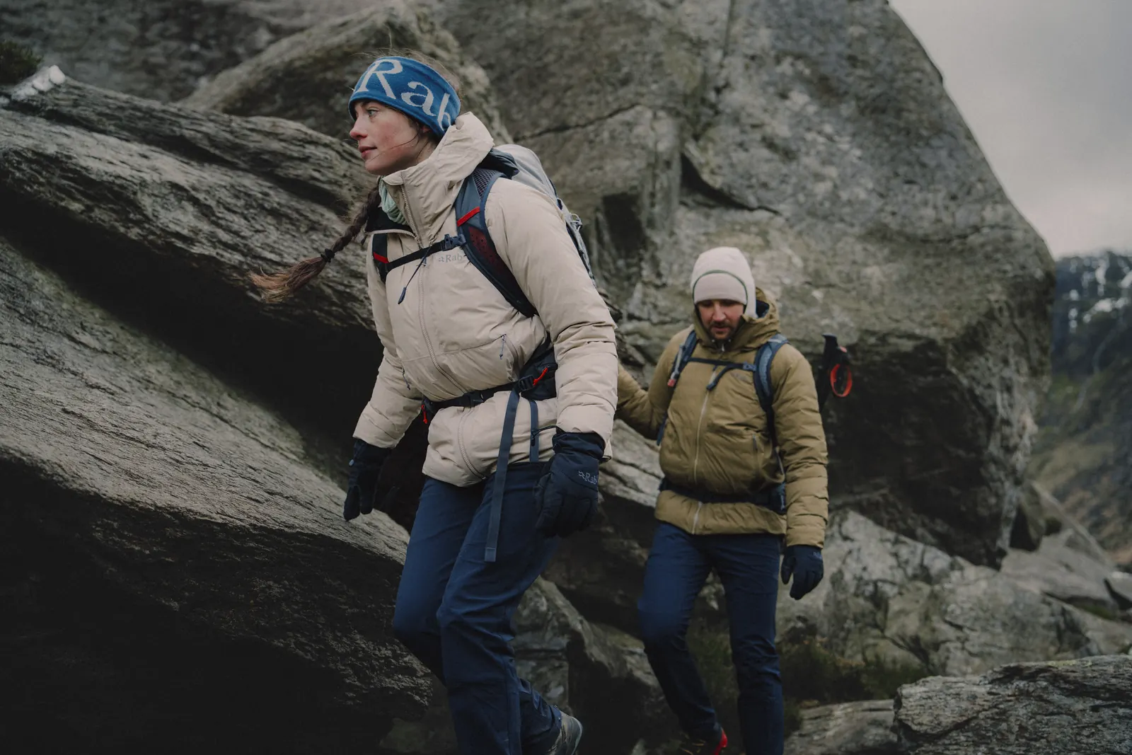 Two hikers in Rab Microlight Shield jackets among boulders in Wales