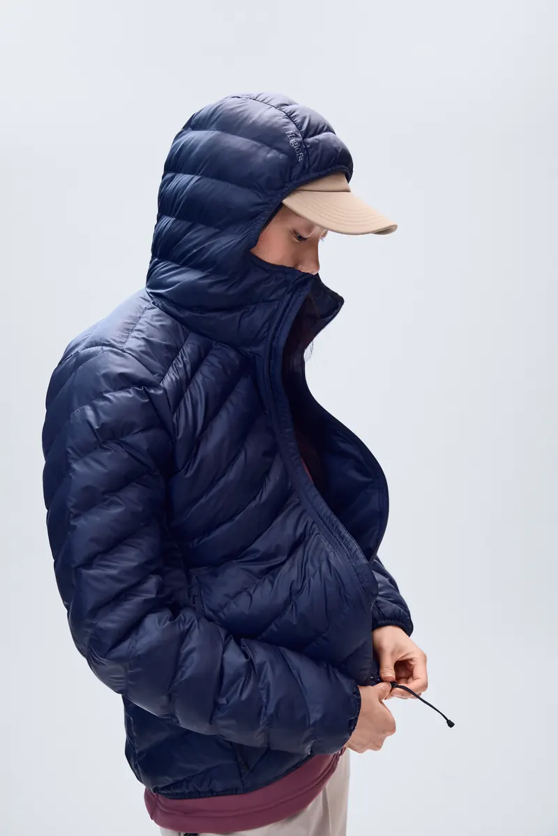 Woman in a navy Haglöfs Särna Mimic II Hood with the hood up